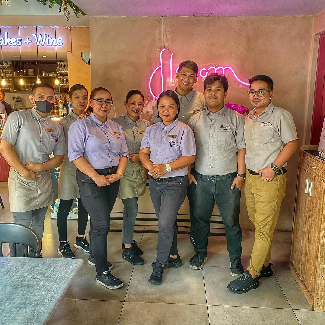 Flossom team with pink neon sign — the people behind your neighborhood cafe