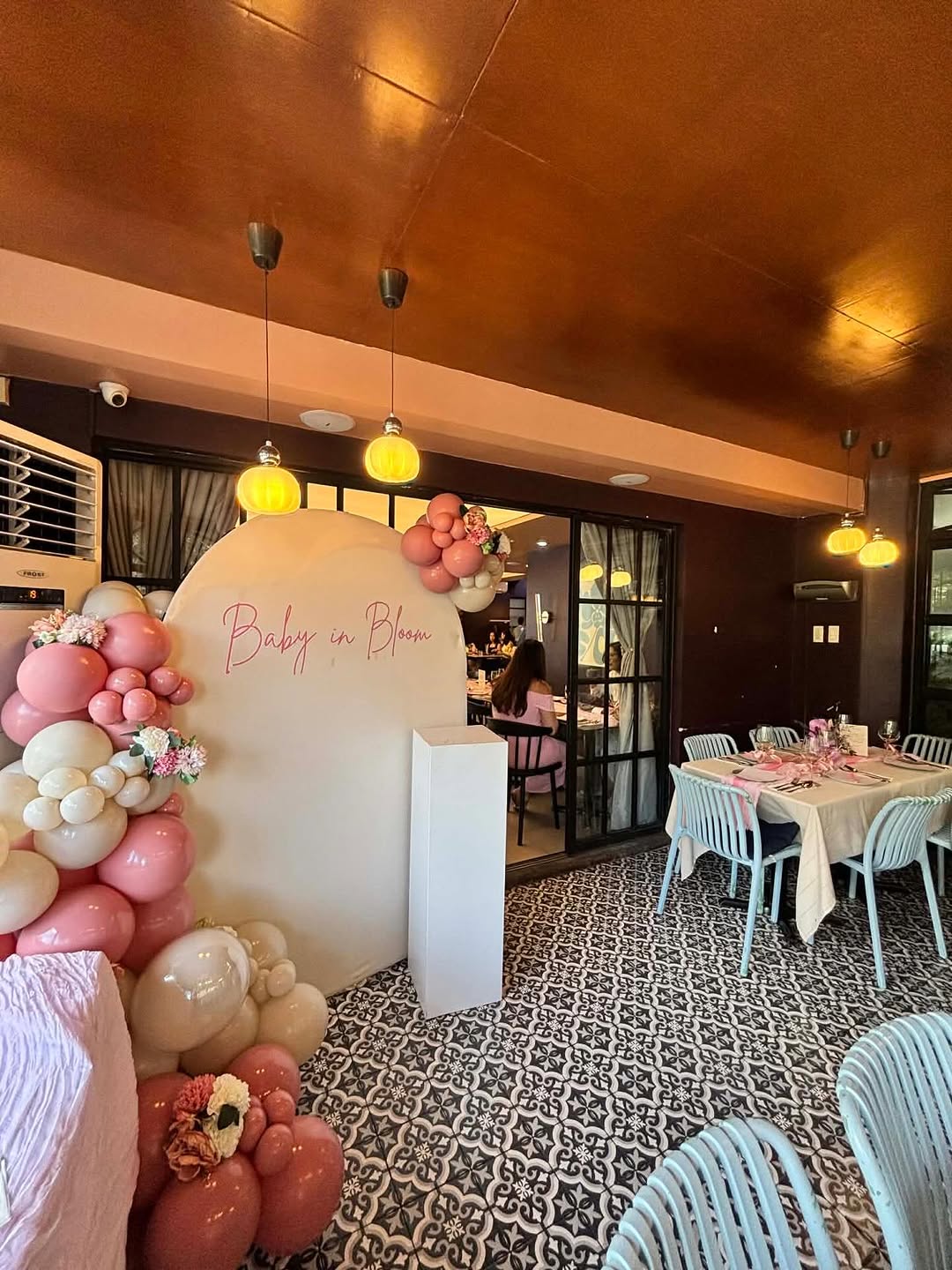Intimate dinner party at Flossom — long table with pink and champagne setup