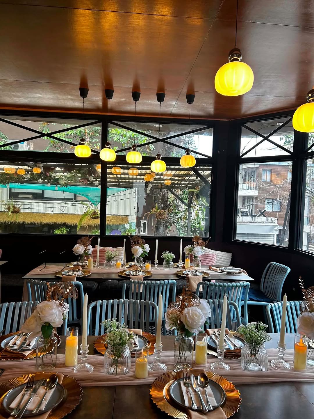 Flossom Glass House event space with yellow globe lights and garden view